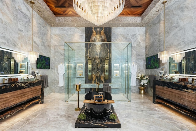 bathroom featuring vanity, a shower with shower door, and a high ceiling