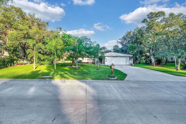 view of front facade with a garage and a front lawn