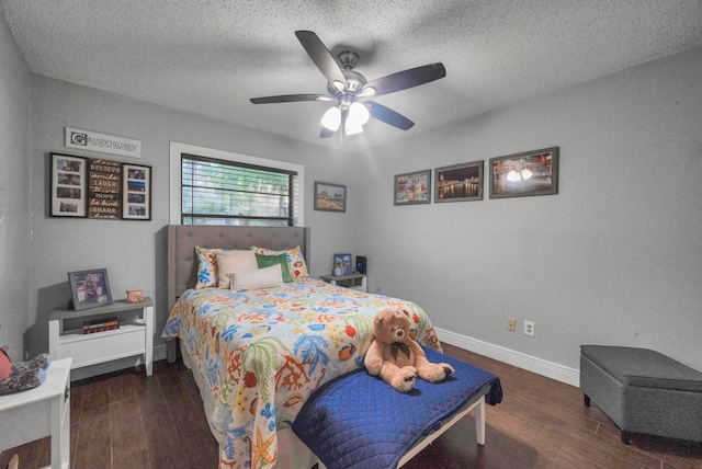 bedroom with a textured ceiling, dark hardwood / wood-style flooring, and ceiling fan