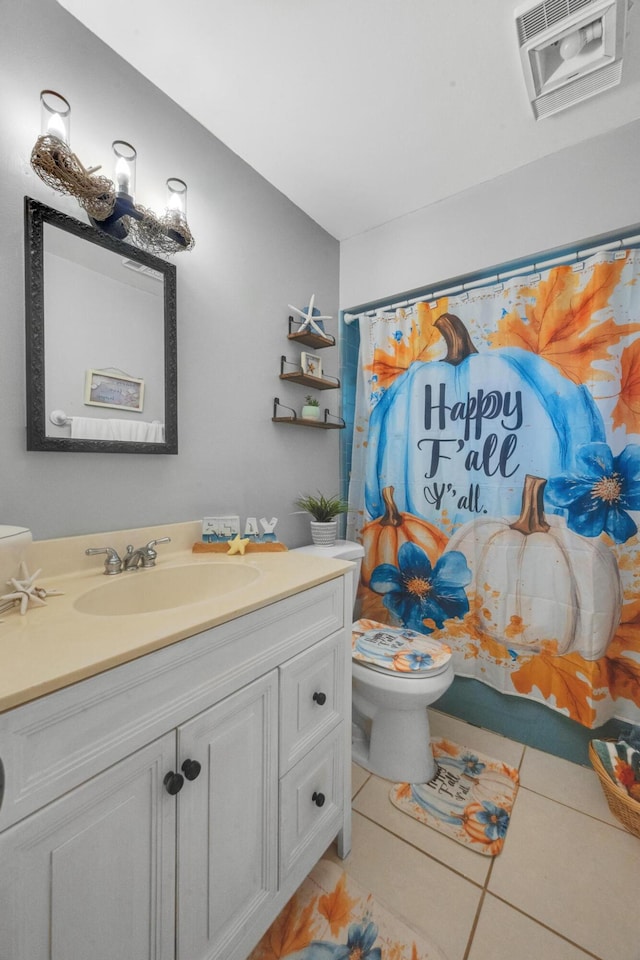 bathroom featuring walk in shower, tile patterned flooring, vanity, and toilet