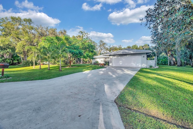 view of front of home featuring a garage and a front lawn