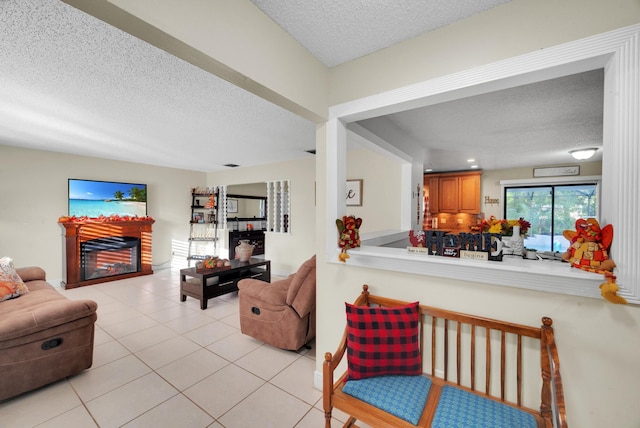 living room featuring light tile patterned flooring and a textured ceiling