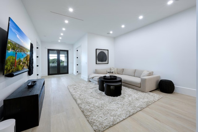 living room featuring french doors and light hardwood / wood-style floors