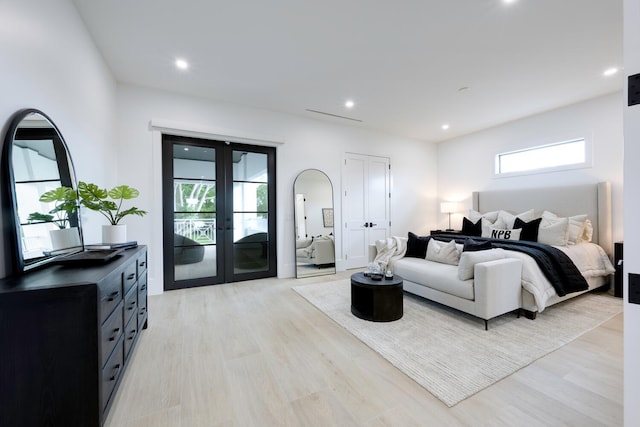 bedroom with light wood-type flooring, access to outside, and french doors