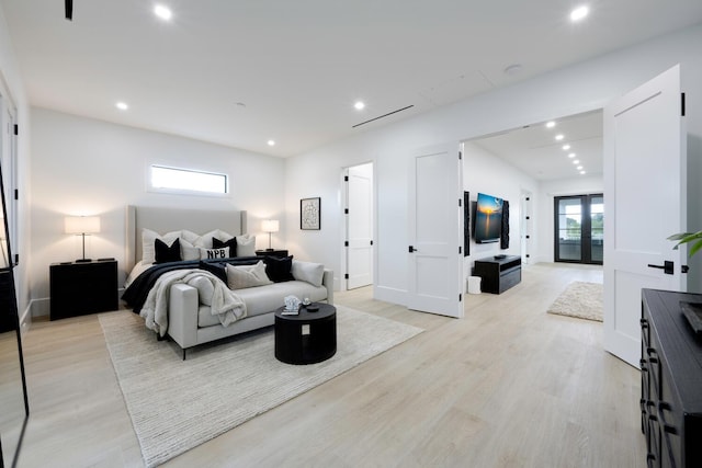 bedroom with french doors and light wood-type flooring