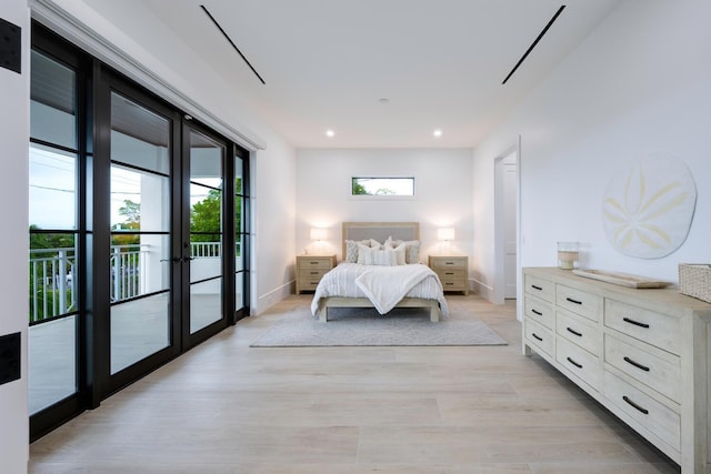 bedroom featuring light hardwood / wood-style floors, access to exterior, french doors, and multiple windows