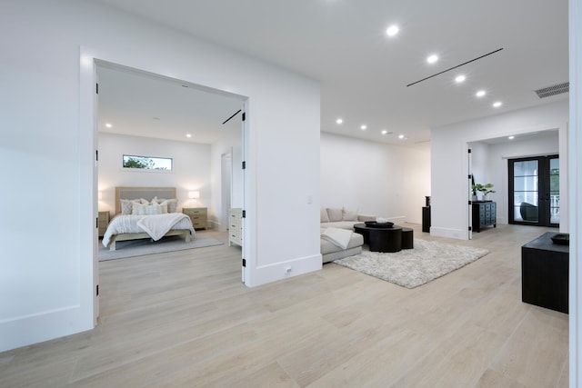 interior space with light hardwood / wood-style floors, a wealth of natural light, and french doors