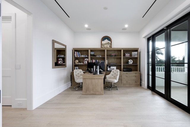 office space featuring french doors and light wood-type flooring