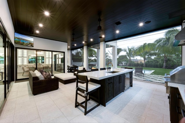 view of patio / terrace featuring a wet bar and exterior kitchen