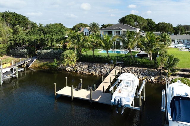 dock area with a lawn and a water view