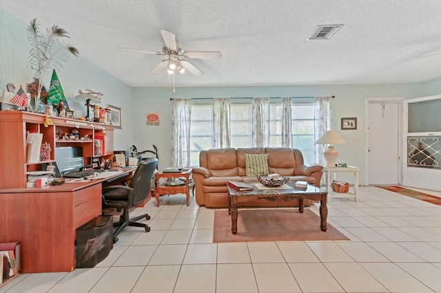 tiled office space featuring ceiling fan and a textured ceiling