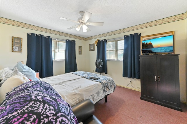 carpeted bedroom with ceiling fan and a textured ceiling