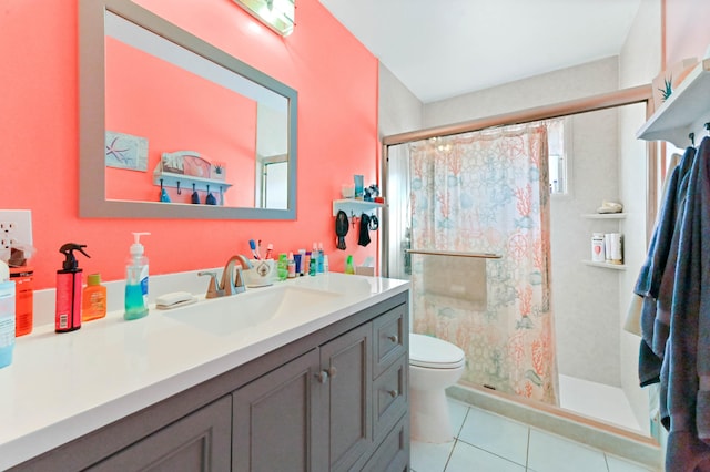 bathroom with a tile shower, toilet, tile patterned flooring, and vanity