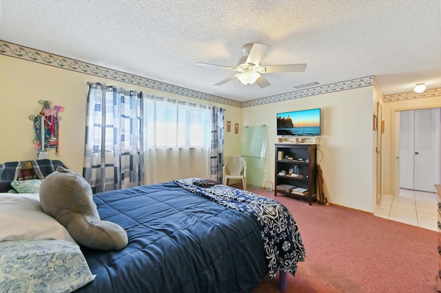 carpeted bedroom featuring a textured ceiling and ceiling fan