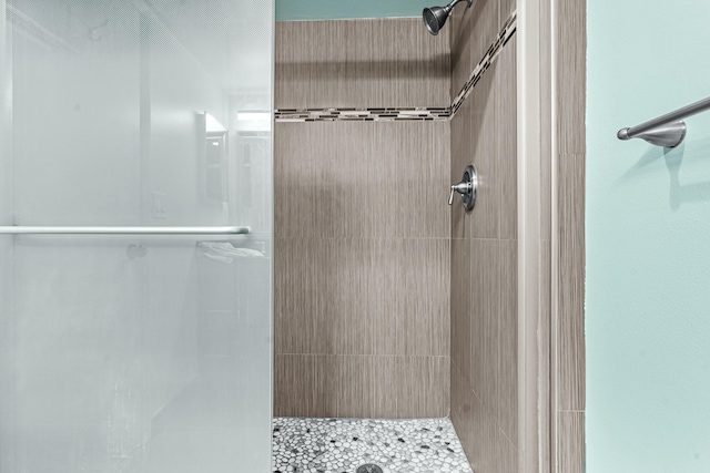 bathroom with tiled shower