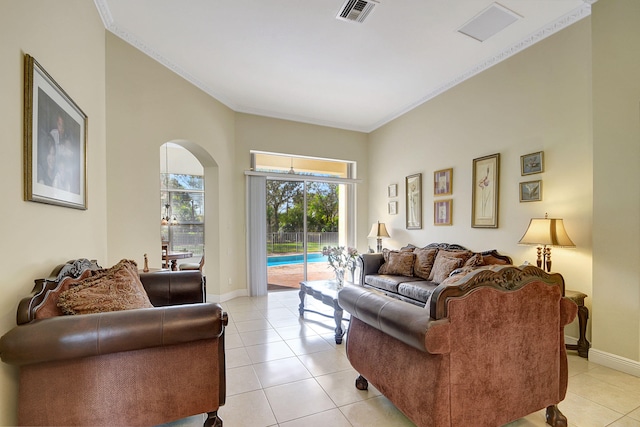 living room with light tile patterned floors and crown molding