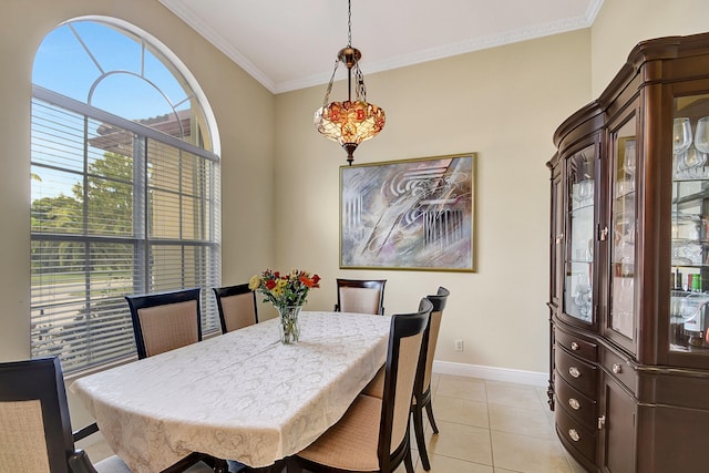 dining space featuring crown molding and light tile patterned floors