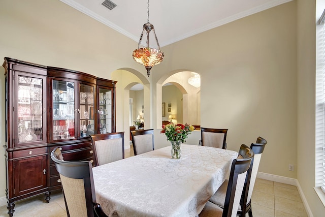 dining area featuring light tile patterned floors and crown molding