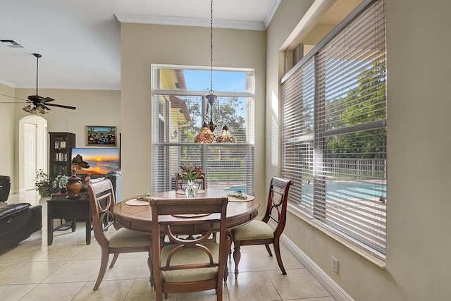 dining area with crown molding, light tile patterned flooring, a healthy amount of sunlight, and ceiling fan