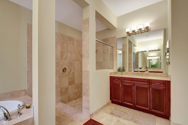 bathroom featuring vanity and separate shower and tub