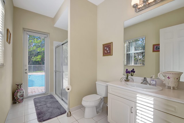 bathroom with tile patterned floors, plenty of natural light, and a shower with door