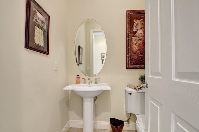 bathroom featuring tile patterned flooring and toilet