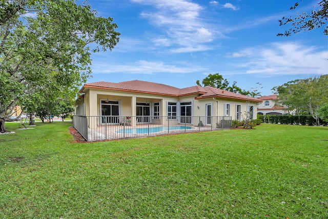 back of property featuring a lawn and a patio area