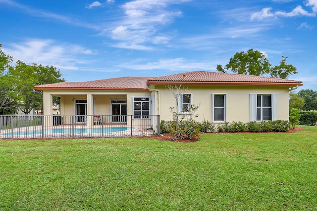 rear view of property with a yard