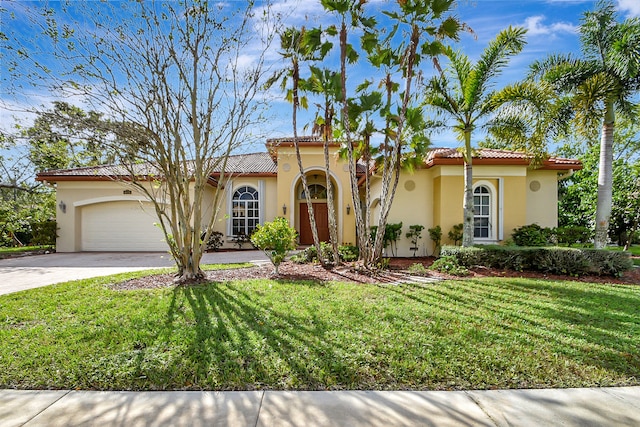 mediterranean / spanish-style home with a garage and a front yard