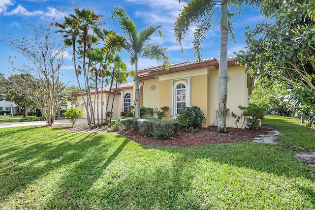 mediterranean / spanish house featuring a front yard