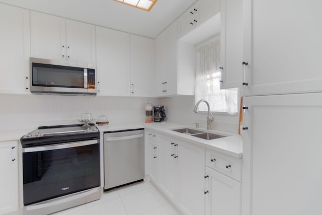 kitchen featuring white cabinets, light tile patterned floors, sink, and appliances with stainless steel finishes