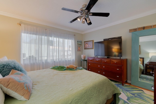 bedroom with ceiling fan and ornamental molding