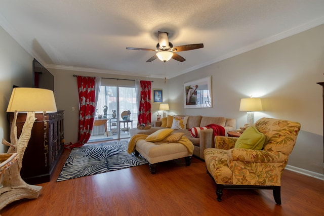 living room with hardwood / wood-style flooring, ceiling fan, and ornamental molding