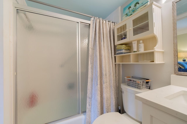 full bathroom with shower / bath combination with glass door, vanity, and toilet