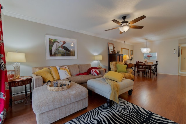 living room with ceiling fan with notable chandelier, dark hardwood / wood-style flooring, and ornamental molding