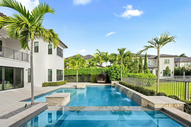 view of swimming pool featuring pool water feature and an in ground hot tub