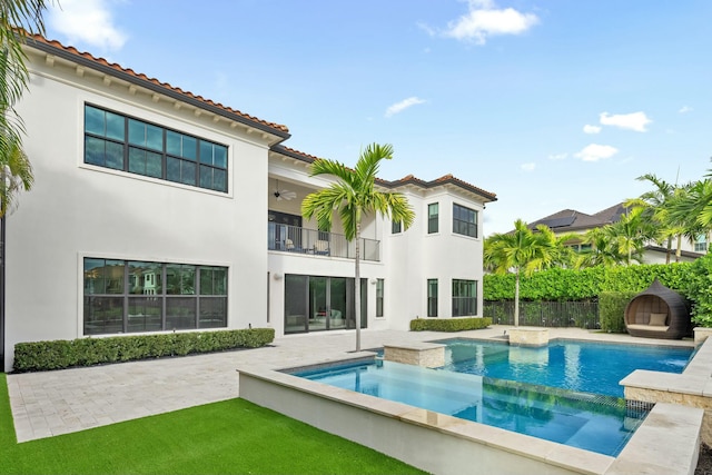 back of house with a swimming pool with hot tub, a patio, and ceiling fan