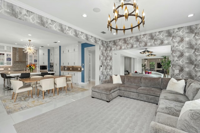 living room with light tile patterned floors, ornamental molding, and a chandelier