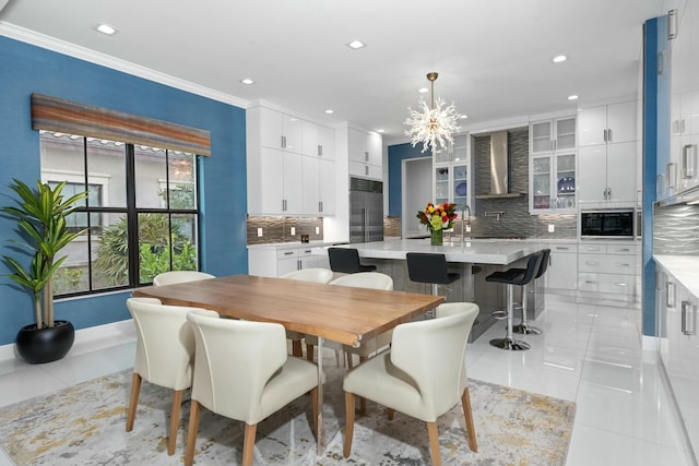 dining area with crown molding, a chandelier, and light tile patterned floors