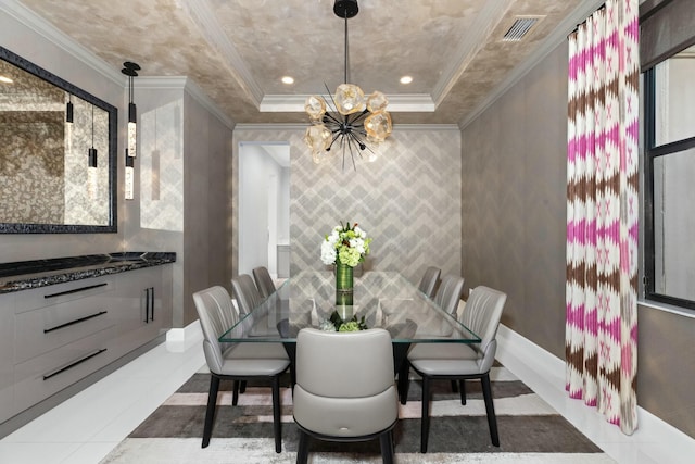 tiled dining space with a chandelier, ornamental molding, and a raised ceiling