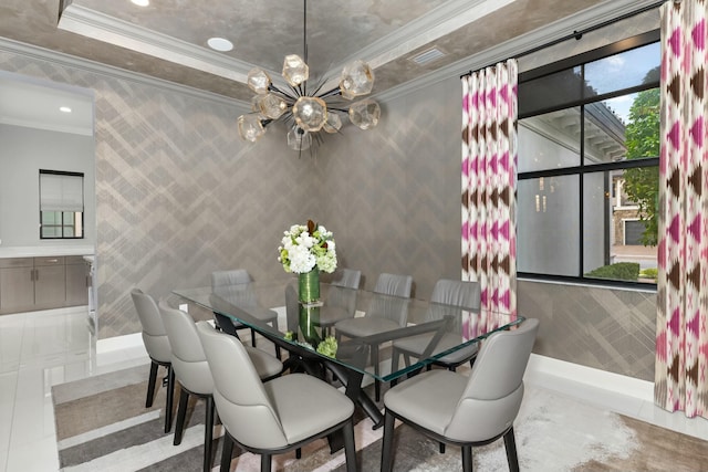 dining room with a raised ceiling, ornamental molding, tile patterned flooring, and a notable chandelier