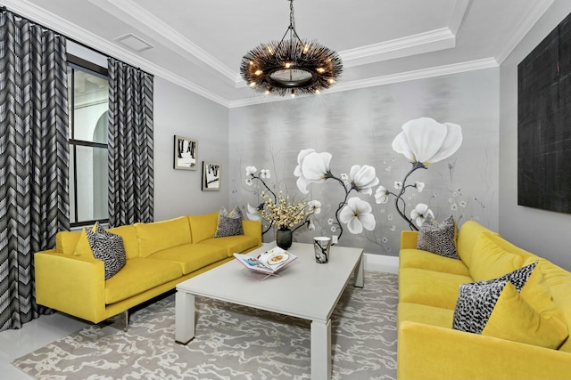 living room with crown molding, a tray ceiling, and a chandelier