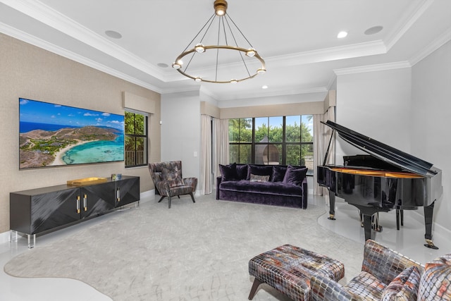 living room with ornamental molding, a tray ceiling, and a notable chandelier