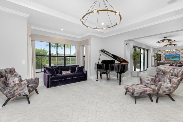 living area with crown molding, an inviting chandelier, and a tray ceiling