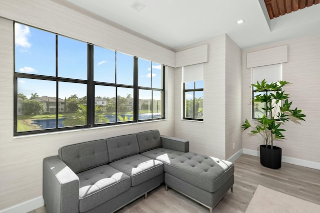 living room featuring hardwood / wood-style flooring and a water view