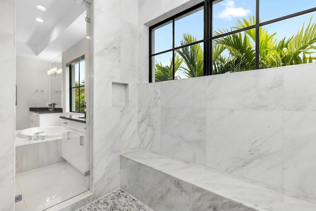 bathroom featuring vanity, a shower with shower door, and an inviting chandelier