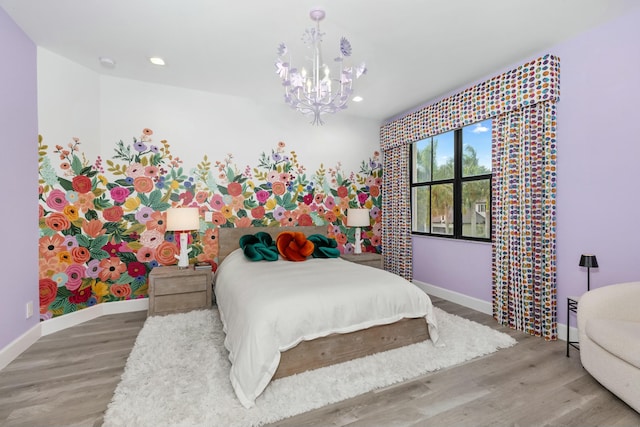 bedroom featuring hardwood / wood-style floors and a notable chandelier