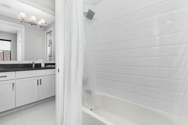 bathroom featuring tile patterned floors, vanity, and shower / bath combo