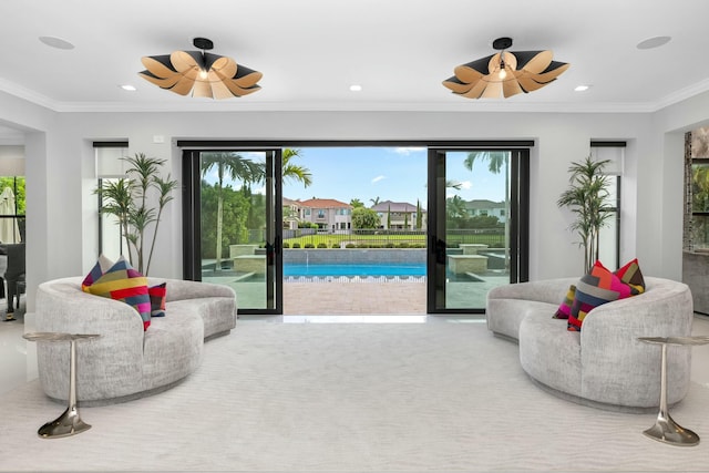 living room featuring ornamental molding and ceiling fan