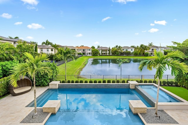 view of pool with a water view, an in ground hot tub, and a lawn